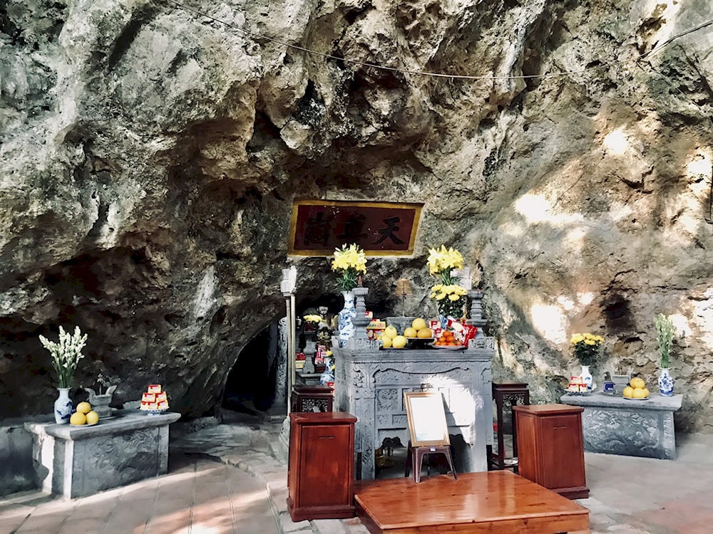 Ancient Buddha statues and carved reliefs glow under the soft light, creating a sacred and tranquil space